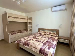 a bedroom with a bed and bunk beds at BarSUN in Bar