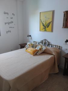 a bedroom with a bed with two pillows on it at Casa El Valle Verde Granada in Lecrin