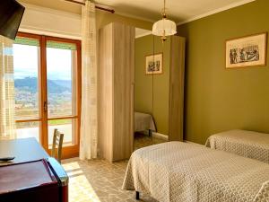 a bedroom with two beds and a large window at Residenza Labanca in Campobasso
