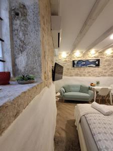 a living room with two beds and a couch at Luna Rooms and Studios Rovinj in Rovinj