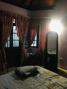 a bedroom with a bed and a large mirror at Home Stay Badulla in Badulla