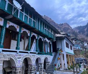 a building with a clock on the side of it at Sunlight Homestay Mohana in Chakrāta