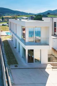 a white house with a view of the ocean at AG Villa Razo Deluxe, con piscina y playa a 400m in Razo da Costa