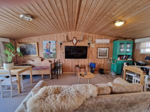 a living room with a couch and a dining room at Arctic Motel and Kautokeino Camping in Kautokeino