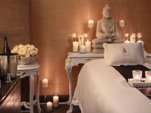 a room with a buddha statue on a table with candles at Hotel Sofitel Los Angeles at Beverly Hills in Los Angeles