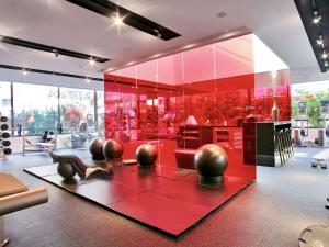 a room with a red wall with balls on a table at Hotel Sofitel Los Angeles at Beverly Hills in Los Angeles