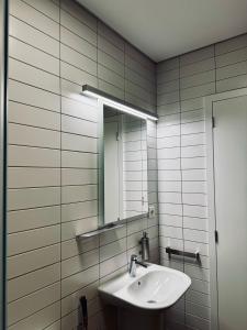 a bathroom with a sink and a mirror at Aliança café & hostel in Angra do Heroísmo +87 photos