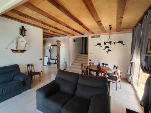 a living room with a couch and a table at Villa Costa. in Tossa de Mar