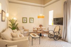 a living room with a couch and a table at Aladro Apartamentos by Valcambre in Jerez de la Frontera