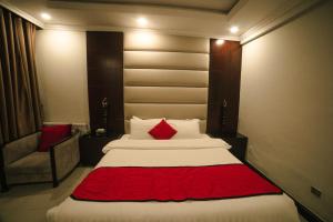 a bedroom with a large bed with a red blanket at Shangrila Hotels and Resort in Murree +82 photos