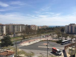 a parking lot with a bus in a city at Apartment Verge de Montserrat in Cambrils