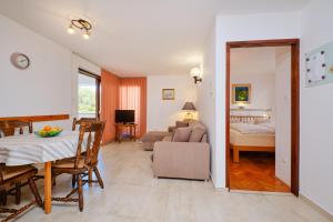 a living room with a dining table and a living room at Apartments Katja in Mali Lošinj