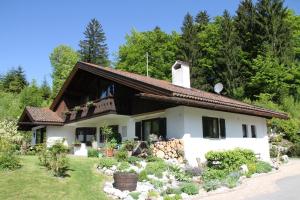 a white house with a brown roof at Arnika in Grainau