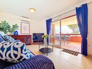 a living room with a couch and a table at Albatros Playa 2 - 5810 in Mar de Cristal