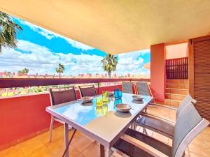 a table on a balcony with a view of the city at Albatros Playa 2 - 5810 in Mar de Cristal