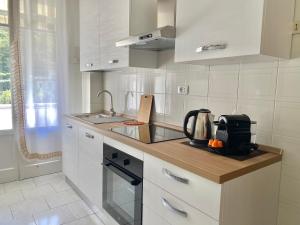 a white kitchen with a sink and a counter top at Ca del Mare - FREE Parking in La Spezia +28 photos