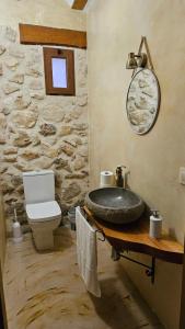a stone bathroom with a sink and a toilet at La Tina, la pariera in Santiago de la Espada +14 photos
