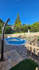 a swimming pool in a yard with a fence at La Tina, la pariera in Santiago de la Espada