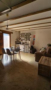 a living room with a table and a couch at La Tina, la pariera in Santiago de la Espada