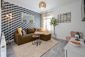 a living room with a couch and a table at Modern Apartment by the Sea in Cleethorpes