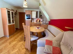 a living room with a table and a couch at Apartment Crystal Rose in Kranjska Gora