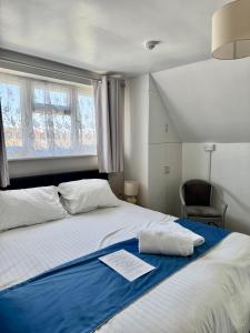 a bedroom with a large bed with a blue blanket at South Sands Hotel in Weston-super-Mare
