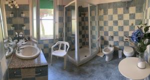 a bathroom with two sinks and a shower and a toilet at Casa Diana in Tarquinia +15 photos