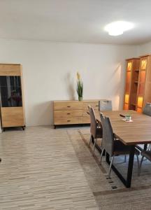 a dining room with a wooden table and chairs at Dům u parku in Znojmo +4 photos