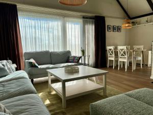 a living room with a couch and a table at Vakantiewoning P3F in Plombières