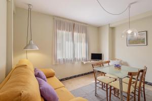 a living room with a couch and a table at El Portal in Sant Llorenc de Morunys
