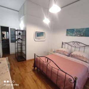 a bedroom with a bed with a metal bed frame at Residenza Regina Margherita in Castellammare di Stabia