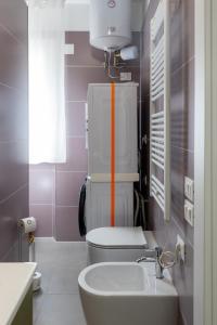 a bathroom with a white toilet and a sink at Amarena Vacanze in Porto Recanati +76 photos