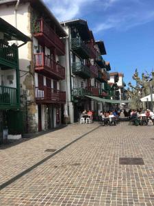 a group of people sitting at tables on a street at Bateau au coeur d'Hendaye in Hendaye +24 photos