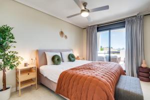 a bedroom with a bed and a large window at Luxury apartment Sunset Golf with spacious private garden & seaview in Estepona +21 photos