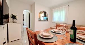 a dining room with a table with a bottle of wine at Apartment Brisas de Nerja in Nerja