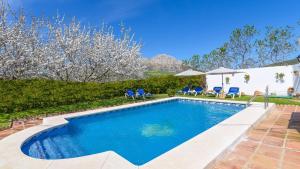 a swimming pool in the backyard of a house at Villa Paqui Villanueva de la Concepción by Ruralidays in Villanueva de la Concepción