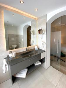 a bathroom with a sink and a mirror at Hotel-Restaurant-Kolb in Illertissen