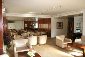 a waiting room with chairs and tables and a restaurant at Amalia in Thessaloniki