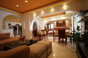 a living room with a couch and a dining room at Iliovasilema in Naxos Chora