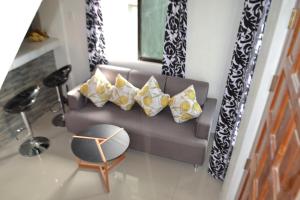 a living room with a couch and a chair at HTL Apartment in Aglalana