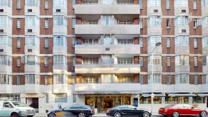 a building with cars parked in front of it at Chelsea Executive Cloisters 571 in London