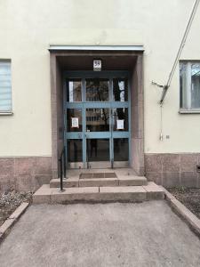 an entrance to a building with a glass door at Spacious and bright apartment for 4 in Helsinki