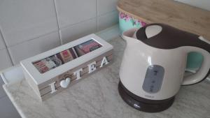 a tea kettle and a box with a remote control at NANA apartment in Ohrid