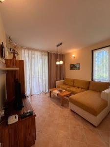 a living room with a couch and a table at Oasis Resort Apartments in Lozenets