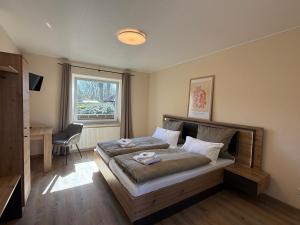 En eller flere senge i et værelse på Hotel zwischen den Meeren