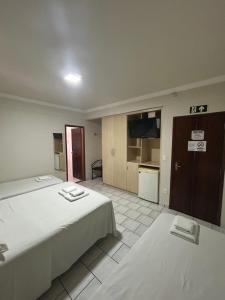 Postel nebo postele na pokoji v ubytování Hotel Parati Arapongas