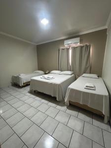 Postel nebo postele na pokoji v ubytování Hotel Parati Arapongas