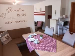 a living room with a table with a red and white table cloth at Ferienwohnung Butterfly in Lam