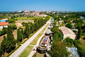 an aerial view of a river with boats on it at Carpe Diem in Sérignan