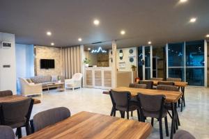 a restaurant with tables and chairs in a room at Konyaalti Suite Hotel in Antalya
